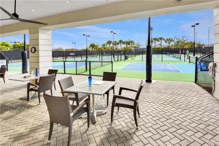 View of tennis court featuring a patio area