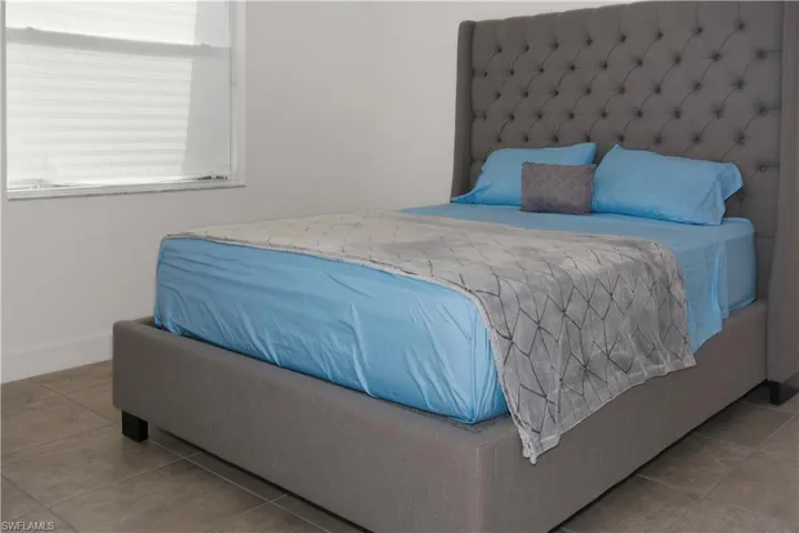 Bedroom with light tile patterned floors