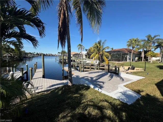 Dock area featuring a yard and a water view