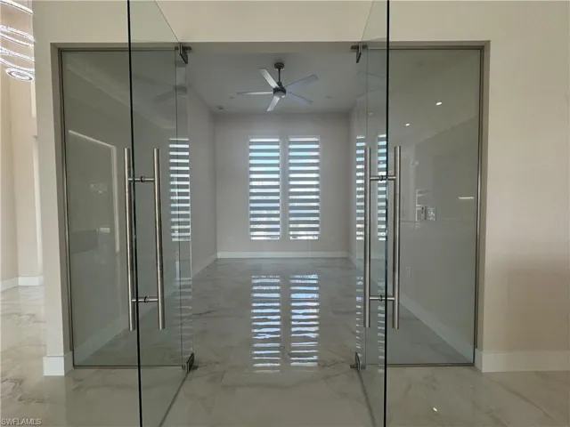 Bathroom featuring ceiling fan and walk in shower