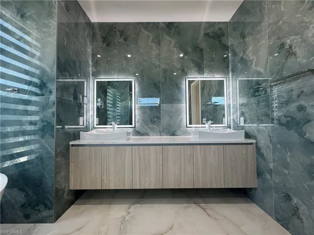 Bathroom with tile walls and vanity