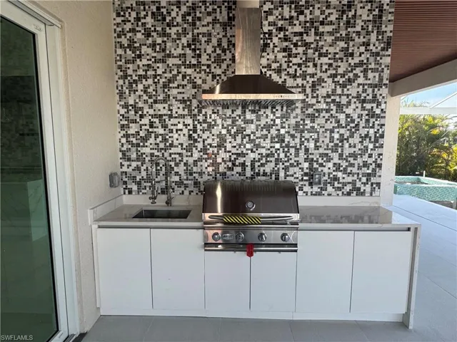 View of patio / terrace with grilling area, sink, and exterior kitchen