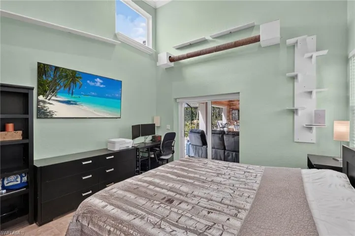 High ceilings, transom window, and sliding glass door to exterior