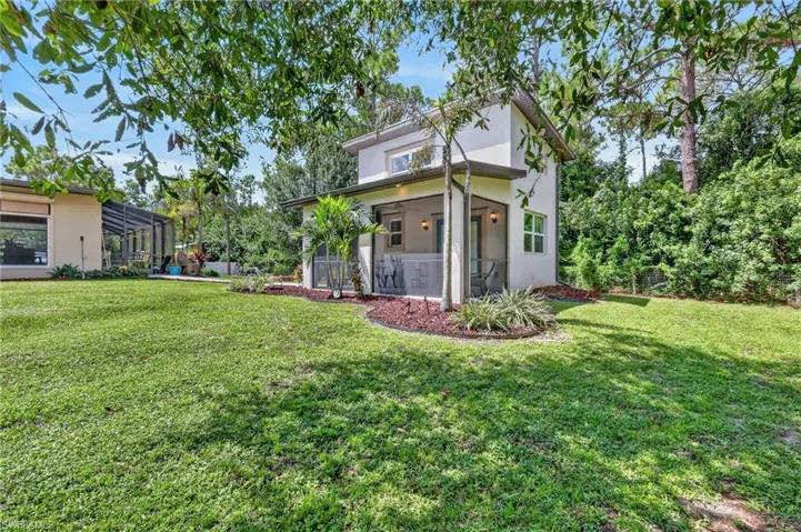 Expansive lawn with mature trees and landscaped beds