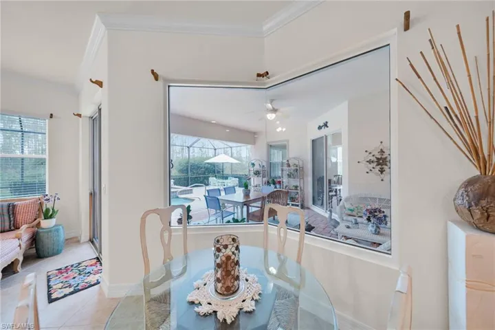 Dining space featuring ornamental molding, tile patterned flooring, and ceiling fan