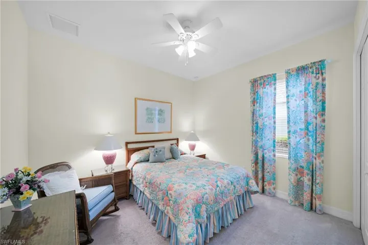 Bedroom featuring light carpet and ceiling fan