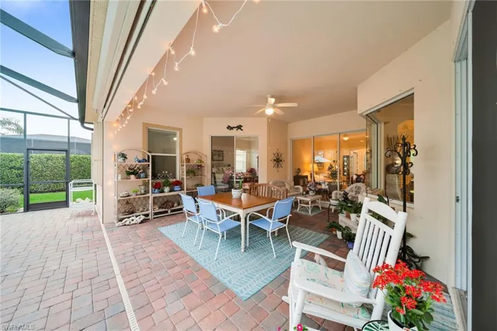 Sunroom featuring a patio area, outdoor dining space, and ceiling fan