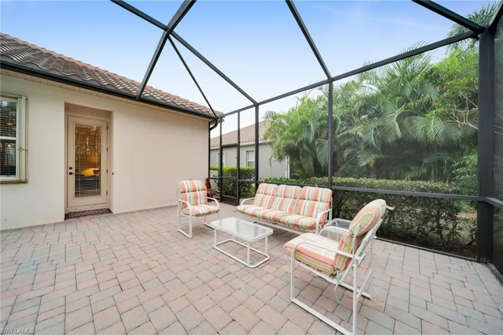 View of patio with a sunroom, glass enclosure, and an outdoor hangout area