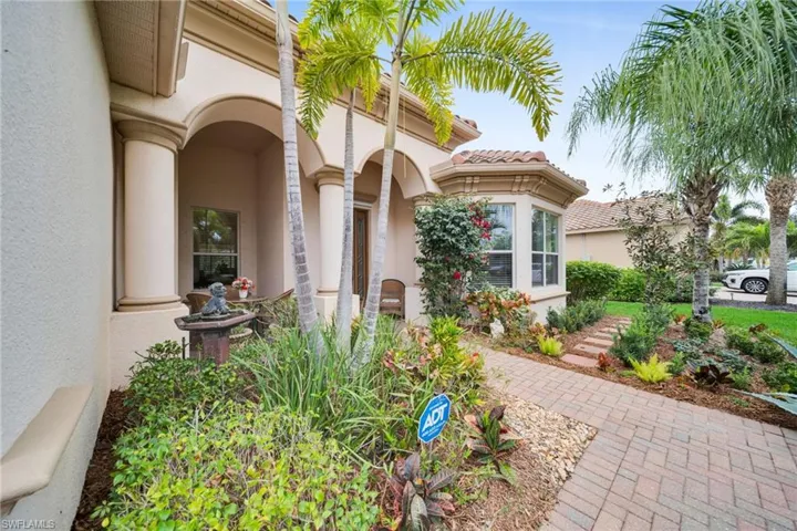 View of exterior entry featuring stucco siding and a tile roof