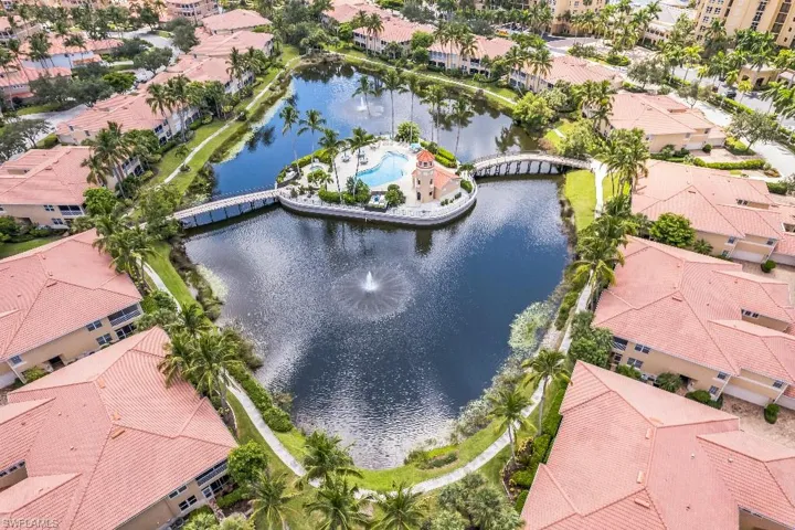 Birds eye view of property with a water view