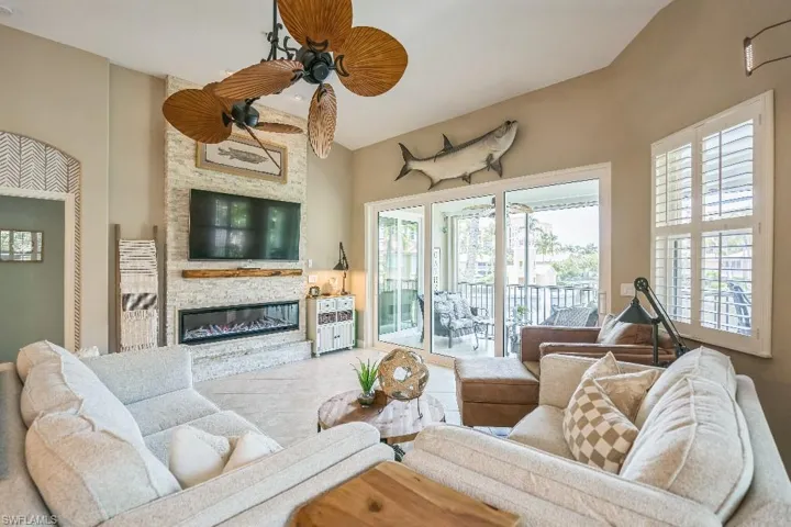 Living room with ceiling fan and a fireplace