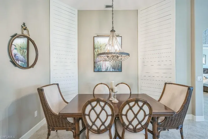Dining room featuring light tile patterned floors and a chandelier
