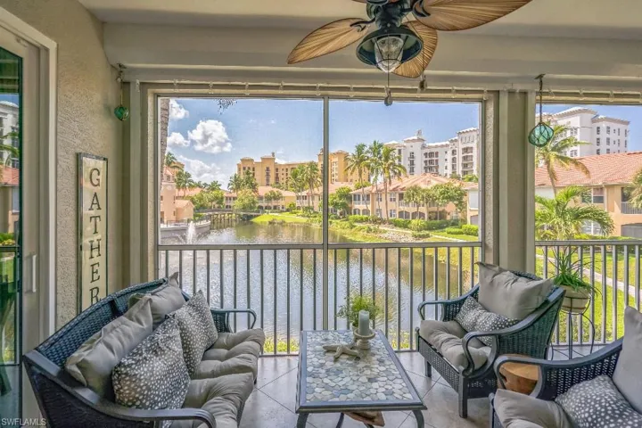 Sunroom featuring a water view and ceiling fan