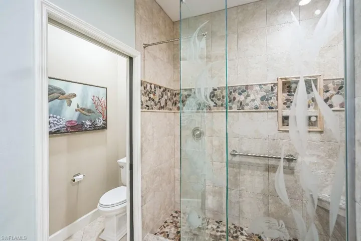 Bathroom with a shower with door and toilet