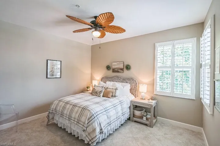 Bedroom featuring light tile patterned floors and ceiling fan