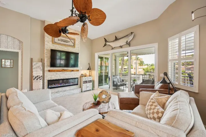 Living room with ceiling fan and a fireplace