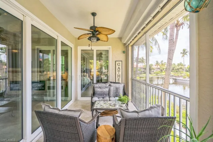 Sunroom / solarium with a water view and ceiling fan