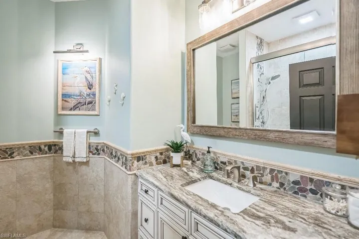 Bathroom featuring vanity and a shower with door