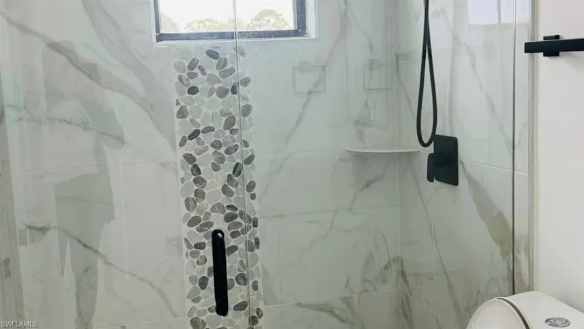 Full bathroom featuring a tile finish shower