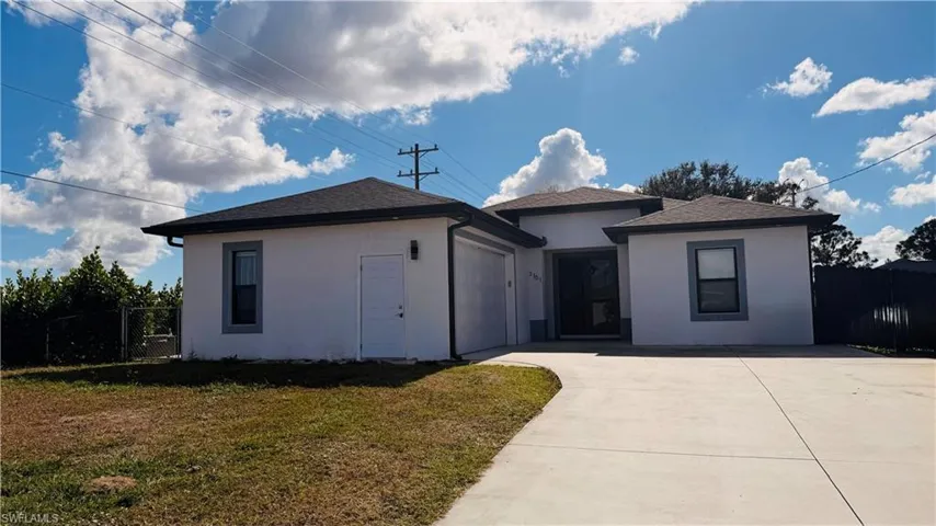 View of front of house with stucco siding, concrete driveway, roof with shingles, and an attached garage