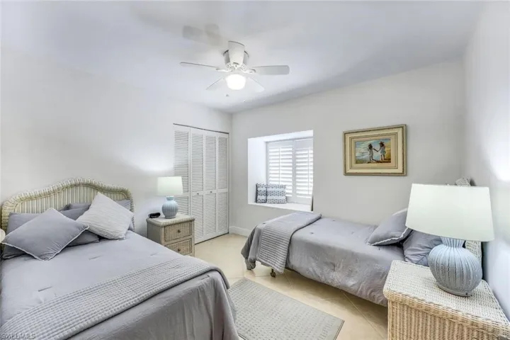 Bedroom featuring ceiling fan and a closet