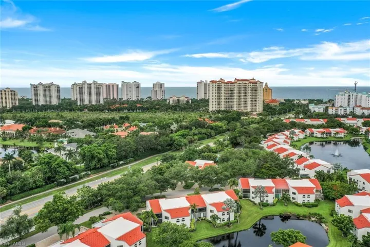 Birds eye view of property with a water view