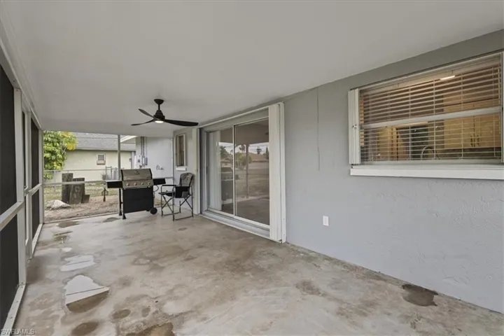 View of patio / terrace featuring grilling area, ceiling fan, and a sunroom
