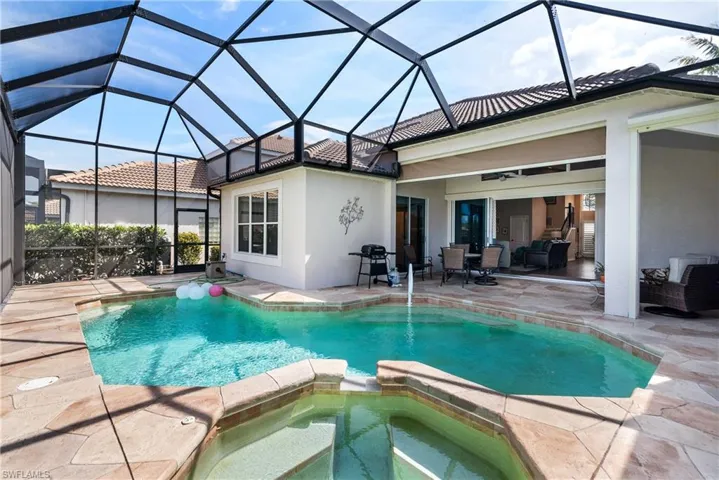 View of swimming pool with a patio area and a pool with connected hot tub