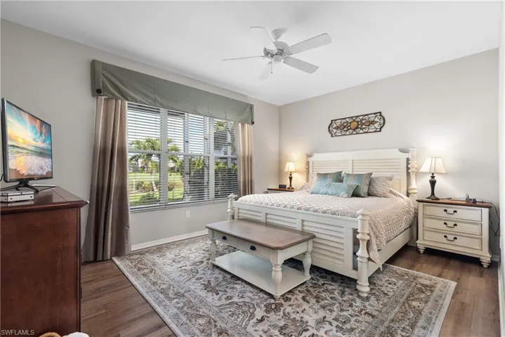 Bedroom featuring wood finished floors, a ceiling fan, and baseboards