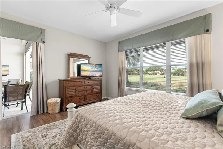 Bedroom featuring baseboards, wood finished floors, and ceiling fan