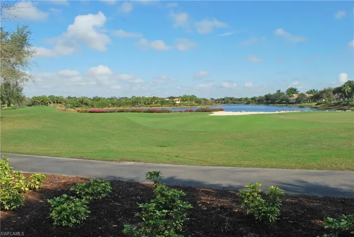 Surrounding community featuring a yard, a water view, and golf course view