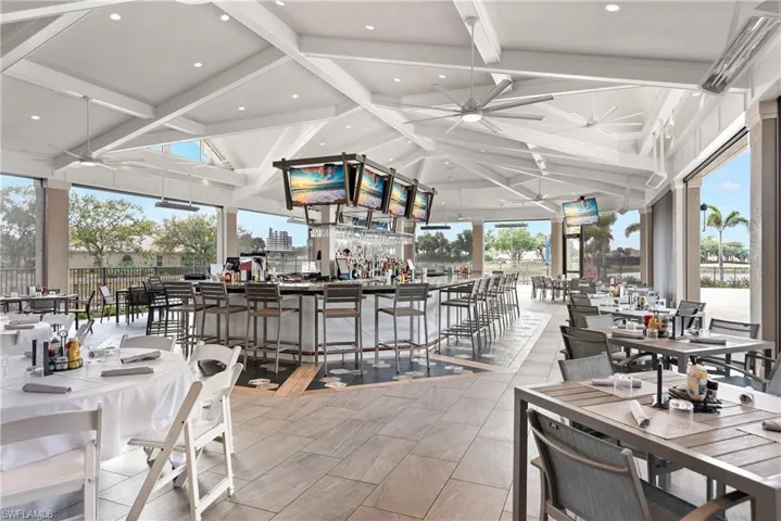 Dining space featuring ceiling fan, a workshop area, and lofted ceiling with beams