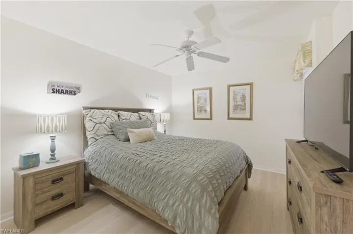 Bedroom with light wood-style flooring and a ceiling fan