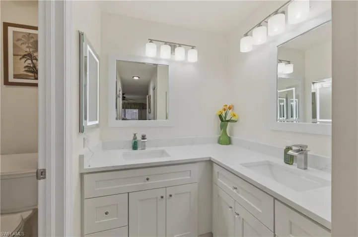 Bathroom featuring toilet and double vanity