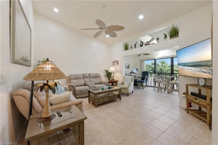 Living room featuring recessed lighting, a ceiling fan, vaulted ceiling, and light tile patterned floors