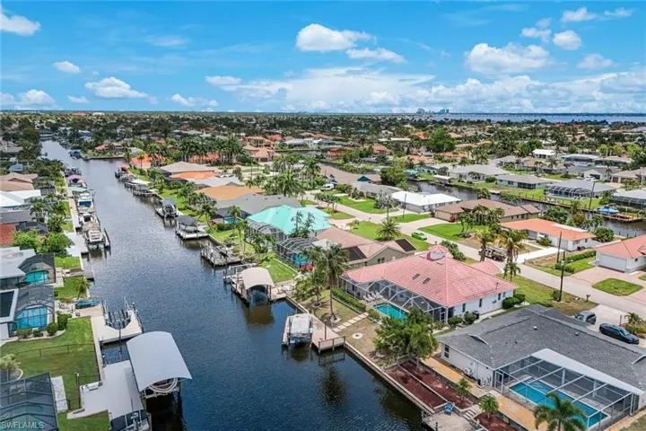 Residential canal system featuring a variety of properties, private boat docks, and screened pools