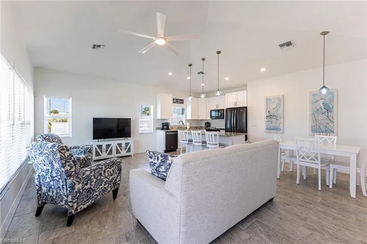 Living room with a ceiling fan and recessed lighting