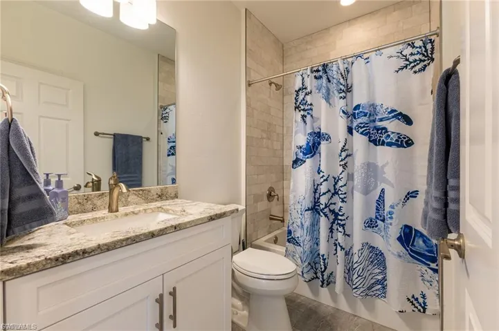 Bathroom featuring shower / tub combo and vanity