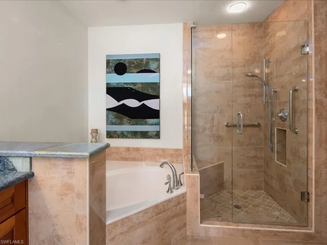 Bathroom with vanity and separate shower and tub