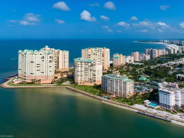 Birds eye view of property with a water view