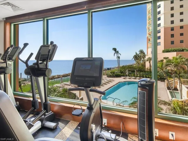 Exercise room with a water view and a healthy amount of sunlight