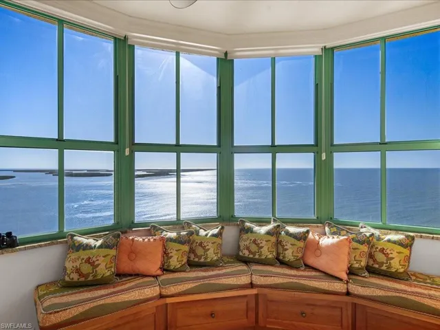 Sunroom with a water view and a healthy amount of sunlight