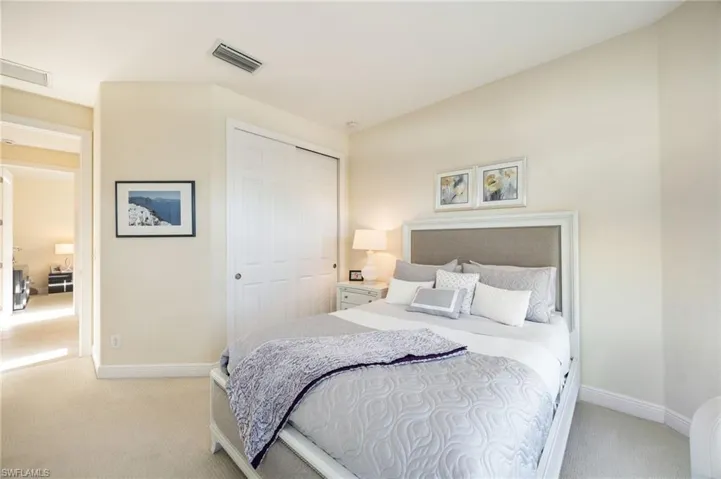 Carpeted bedroom with baseboards and a closet