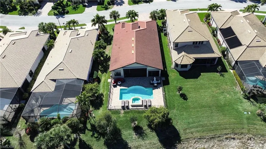 Aerial perspective of suburban area featuring a pool area