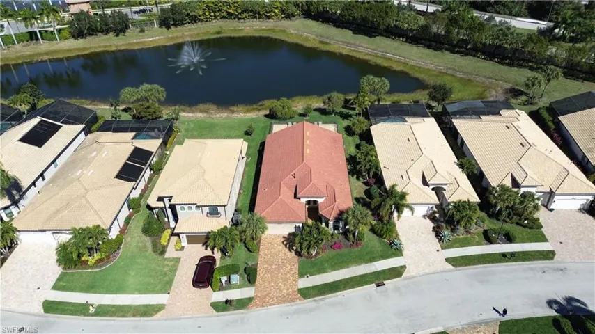 Aerial perspective of suburban area featuring a large body of water