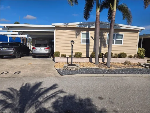 View of front of property with a carport