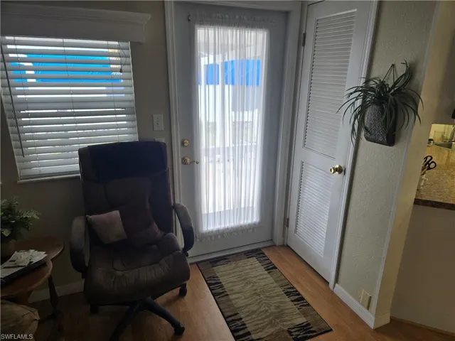 Doorway to outside with hardwood / wood-style floors and a wealth of natural light