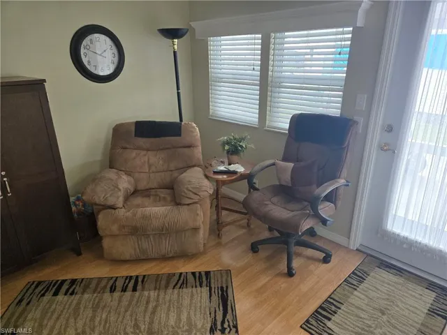 Sitting room featuring a healthy amount of sunlight and wood-type flooring