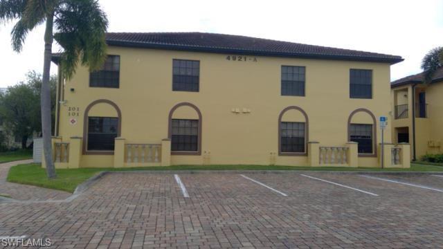 Exterior of building featuring pavered parking lot