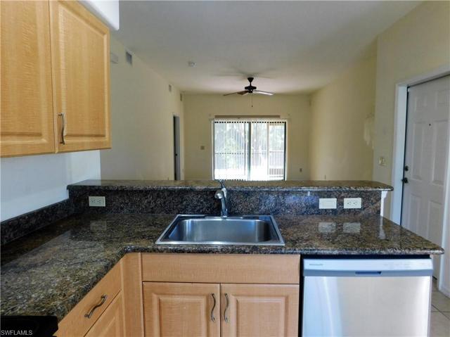 Kitchen overlooks Great room with counter breakfast bar.